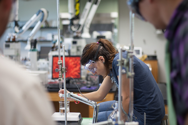 Chemistry measuring liquid contents in Chemistry lab.