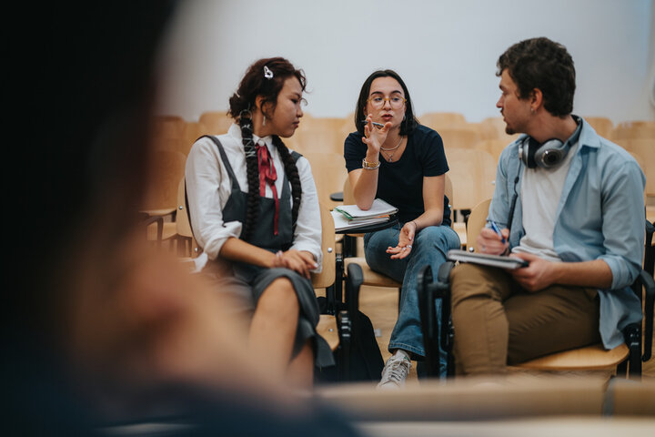 Three sociology students working together during a class activity