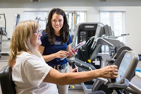 UNC trainers guiding clients in the gym.