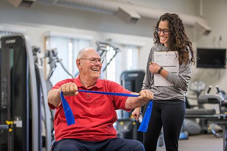 UNC trainers guiding clients in the gym.