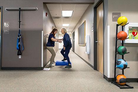 A client working mobility training with a trainer.