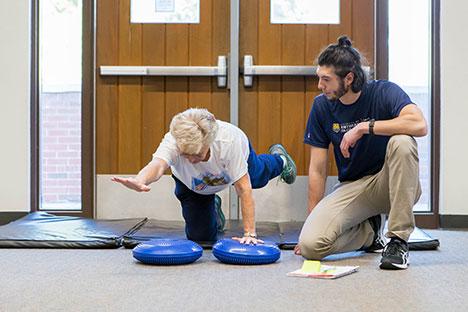 A client working with a trainer in the gym.