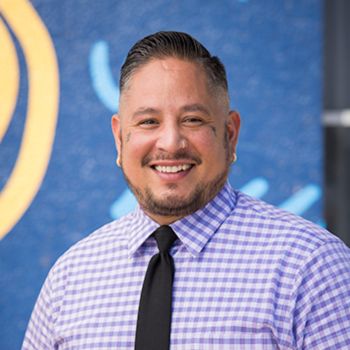 A professional headshot of Joseph Arguello