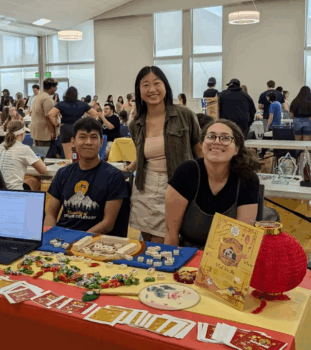 Three Students at the Chinese Club booth