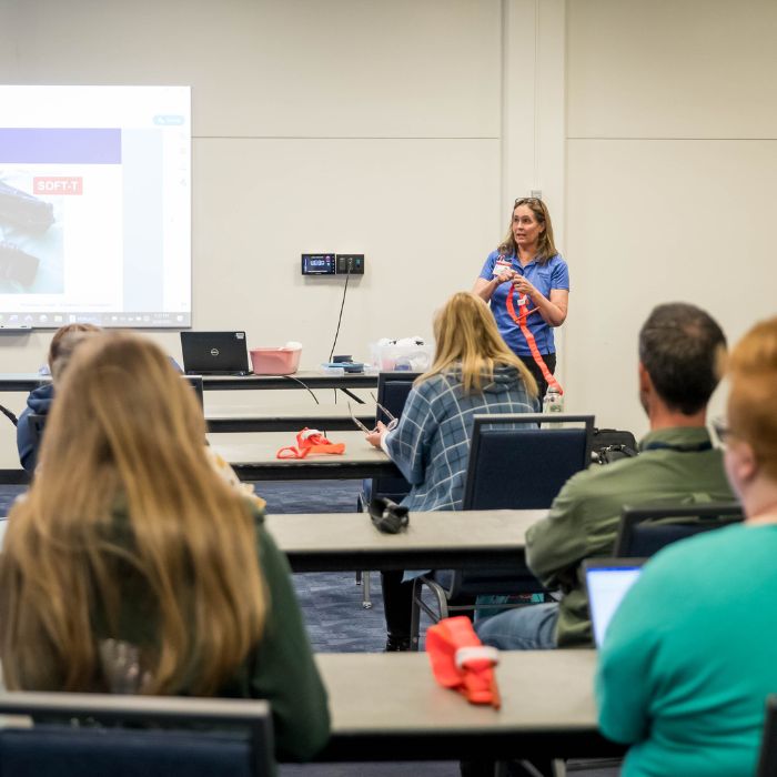 An instructor teaches a classroom of participants in a Stop the Bleed training session.