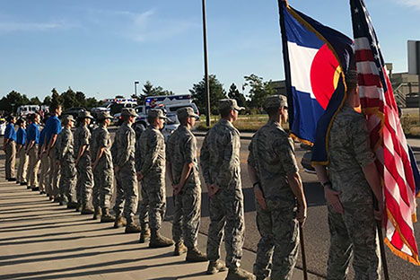 Cadets holding American and Colorado flags.