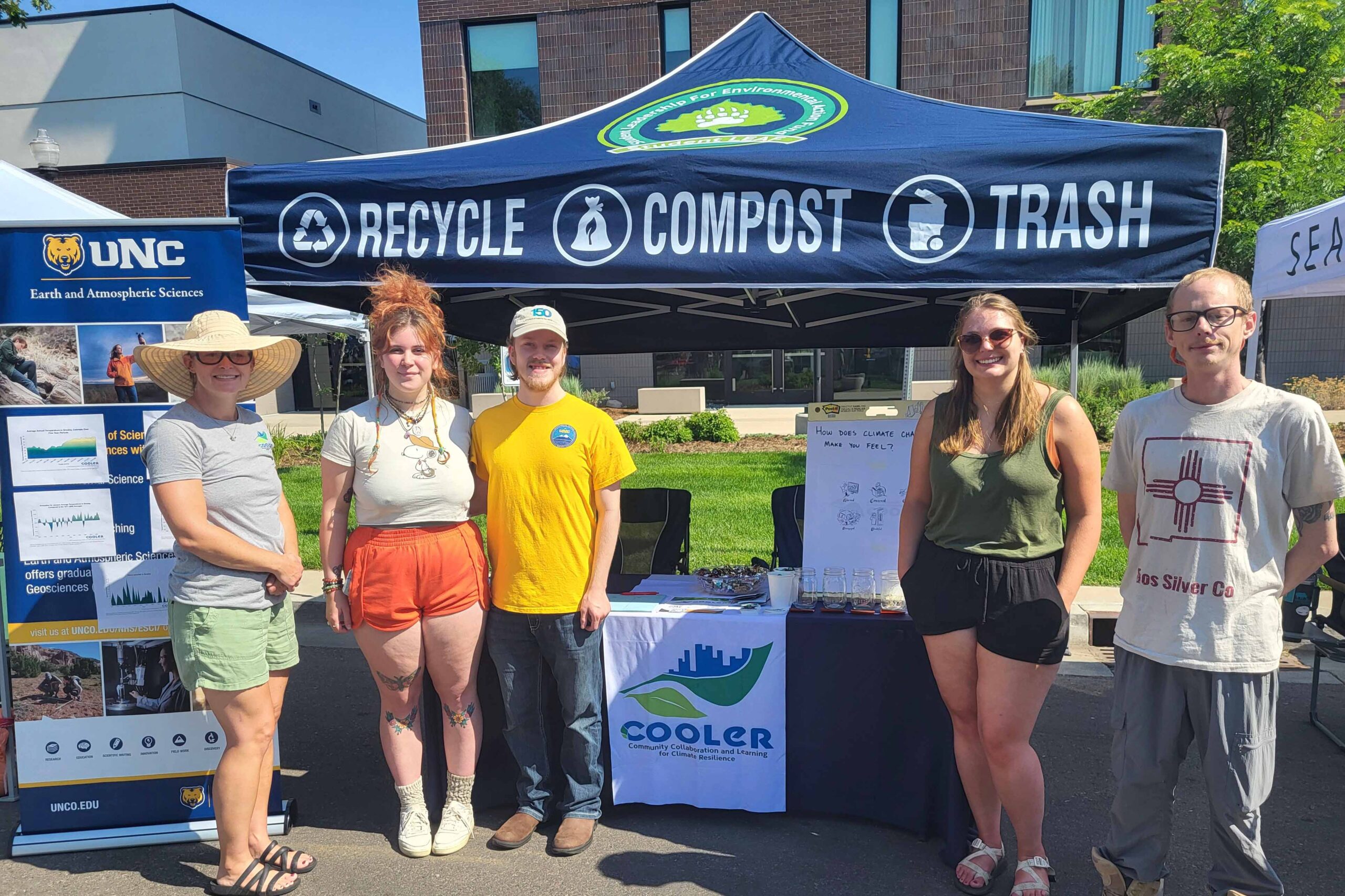 A group of faculty and students in front of a COOLER tent.