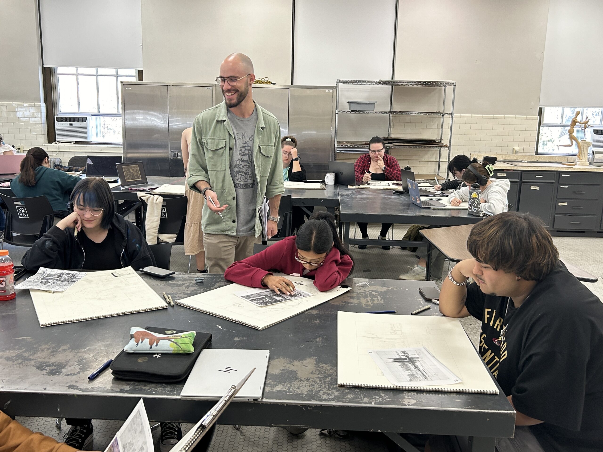 Students at a table in drawing class with faculty member Matt McHugh.