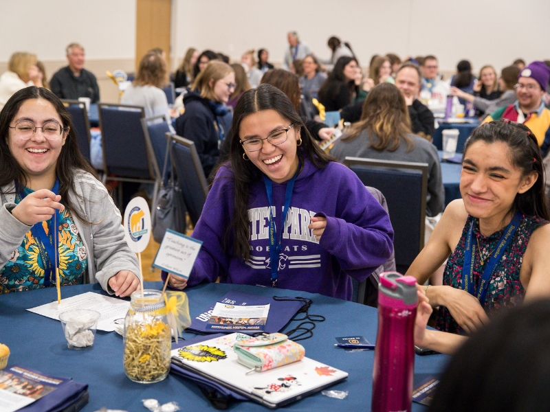 Group of students at a table at the future teacher conference