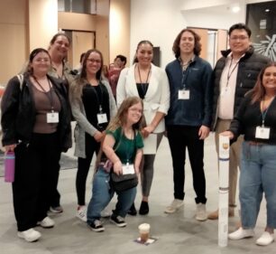 A team of researchers together at a convention.