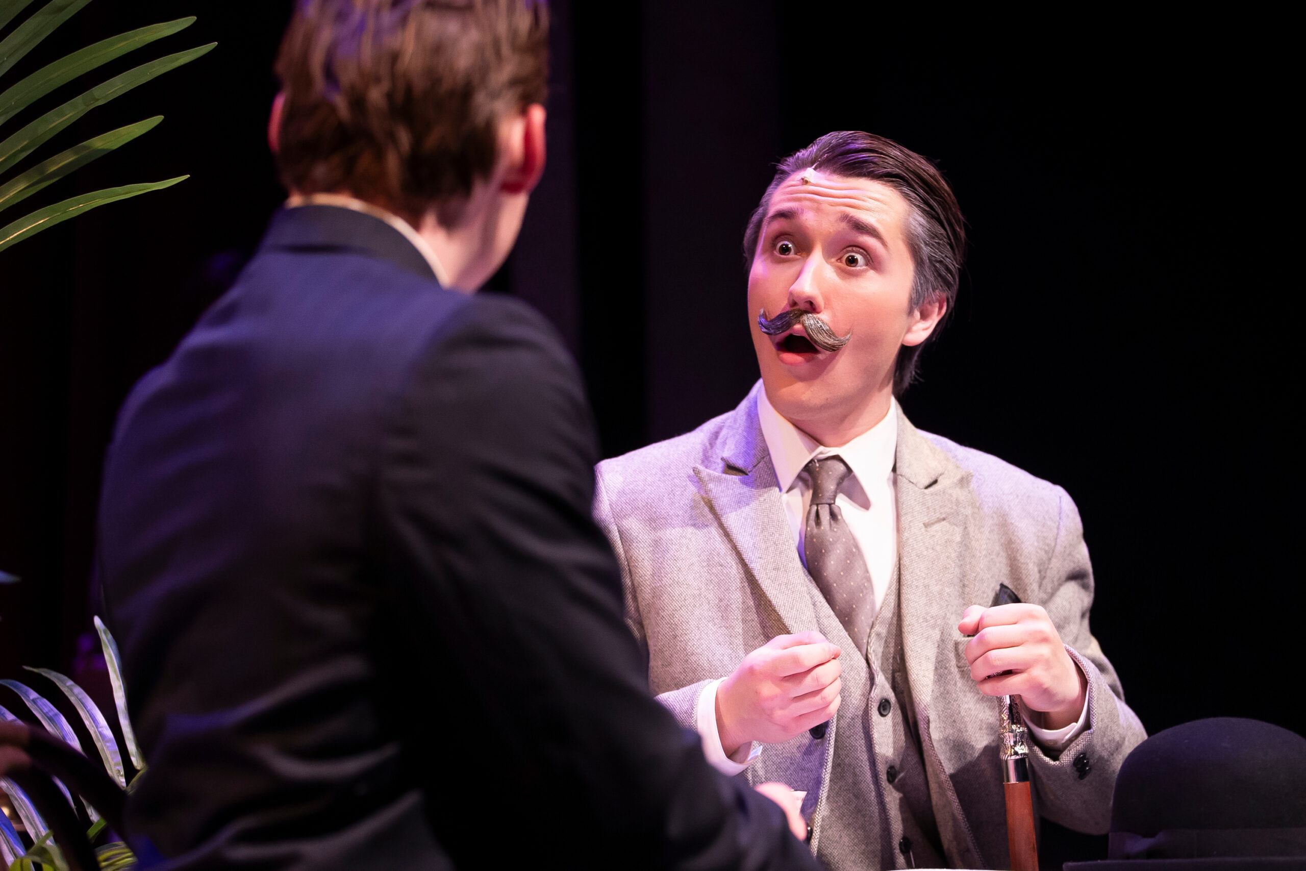 An actor looking surprised in the play Murder on the Orient Express.