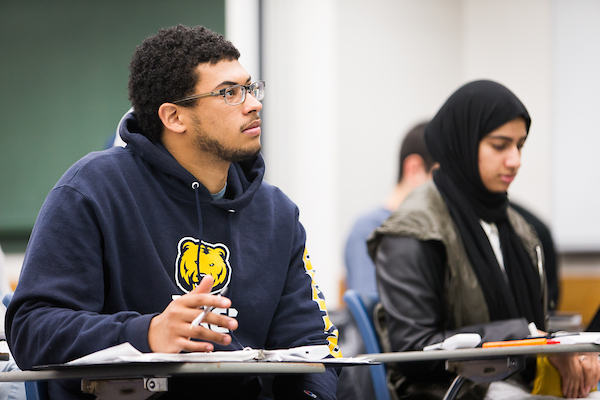 Two economics students paying attention in class