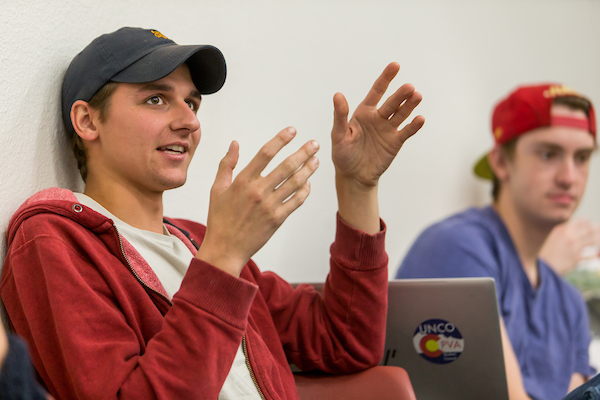 Two students engaged in discussion during an English literature class