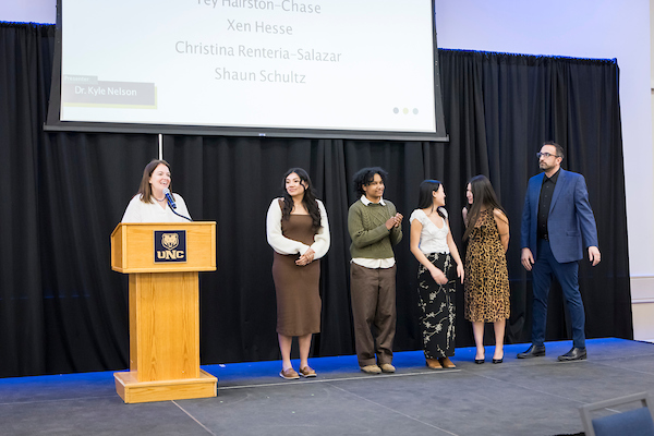 Four students, and a faculty member, and Dr. Kyle Nelson at the HSS Convocation 2025