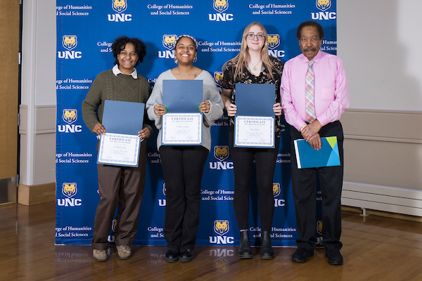 Professor and Chair George Junne with three students at the HSS honored scholars convocation