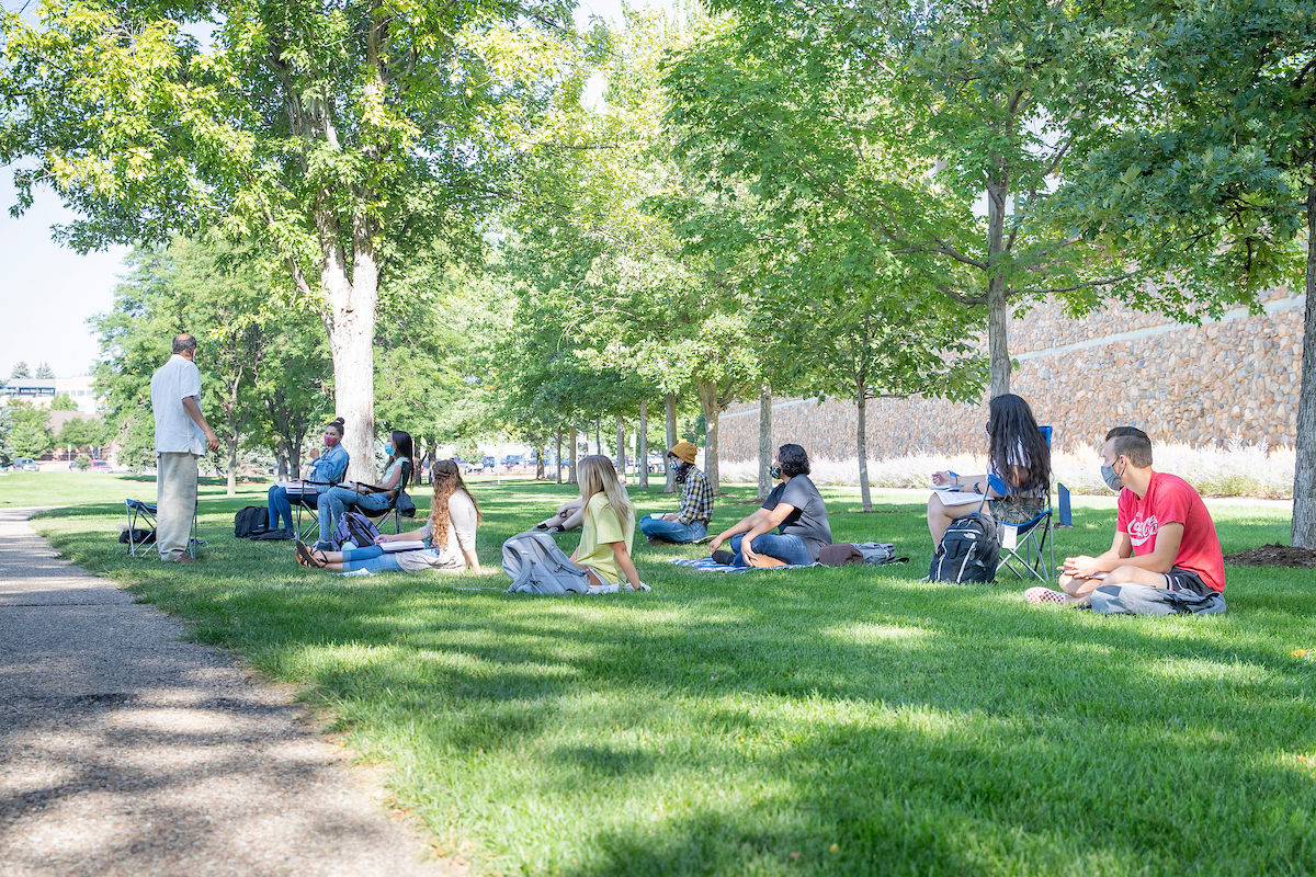 Stan Luger, a professor, teaching a political science outside.