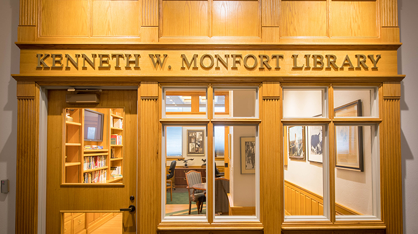 ntrance to the Kenneth W. Monfort Library, featuring a wooden facade with large windows and the library's name prominently displayed above.