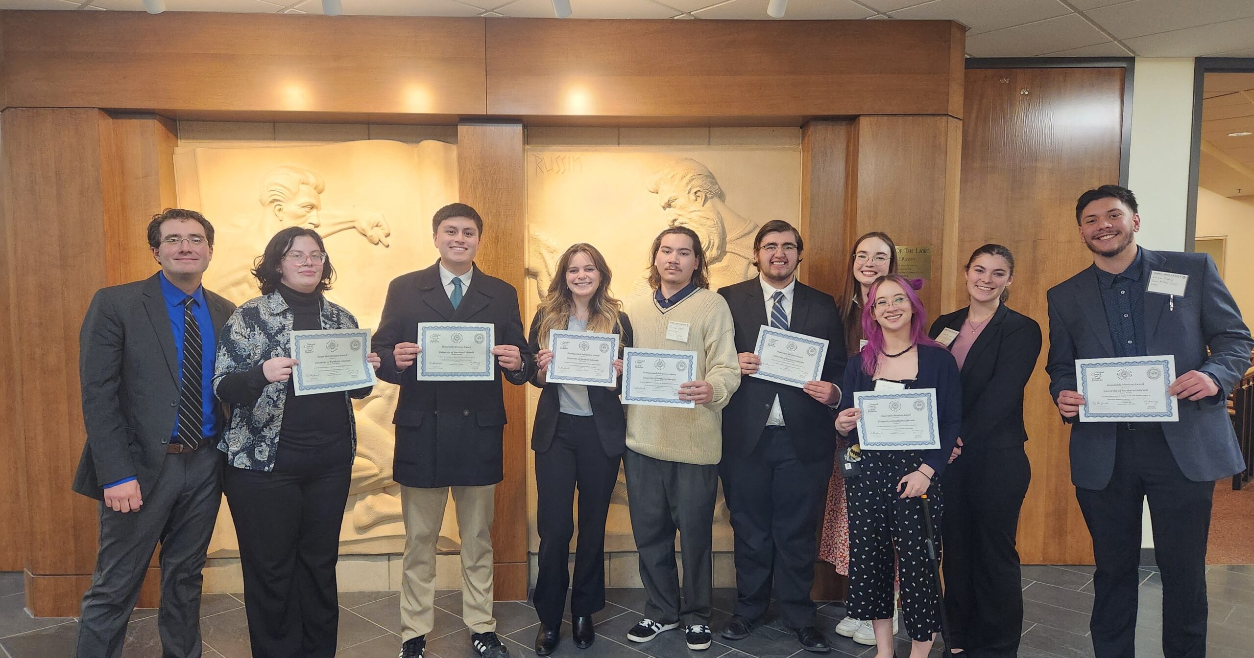 9 students with a professor at the Model Arab League