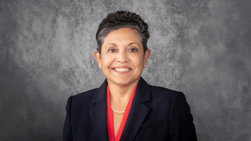Headshot photo of Annette Martinez with a grey background