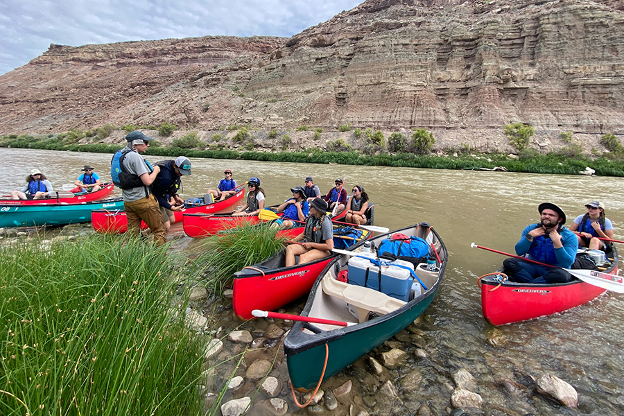 large group canoeing through a canyon