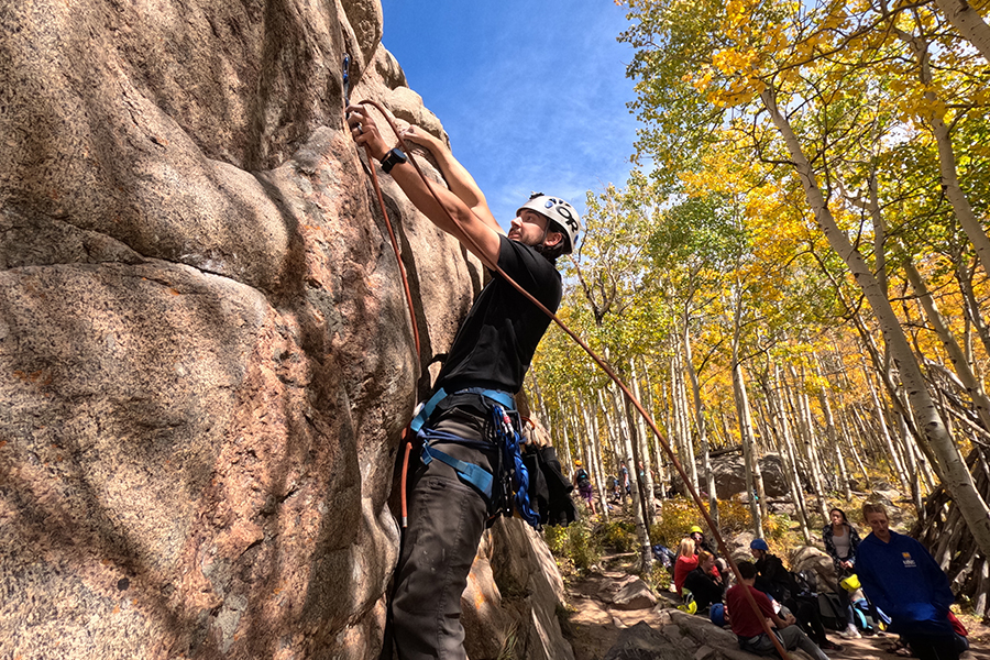 person rock climbing outside
