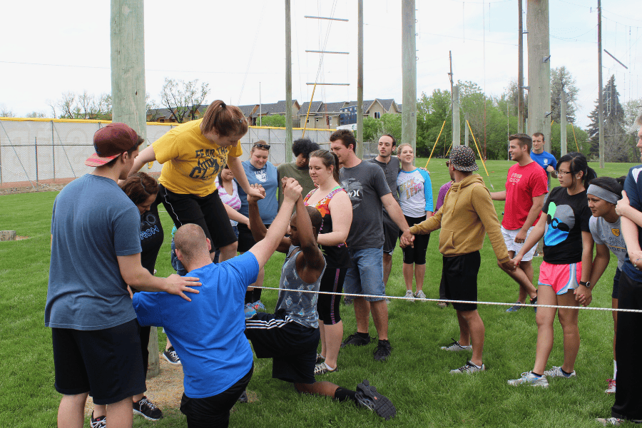 large group holding hands doing a team building activity