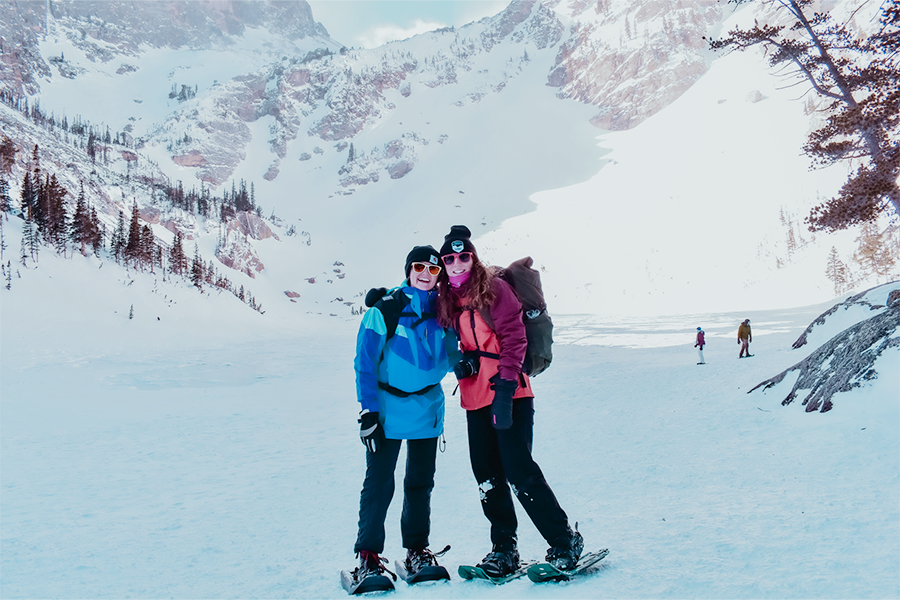2 students posing for a photo at a frozen lake