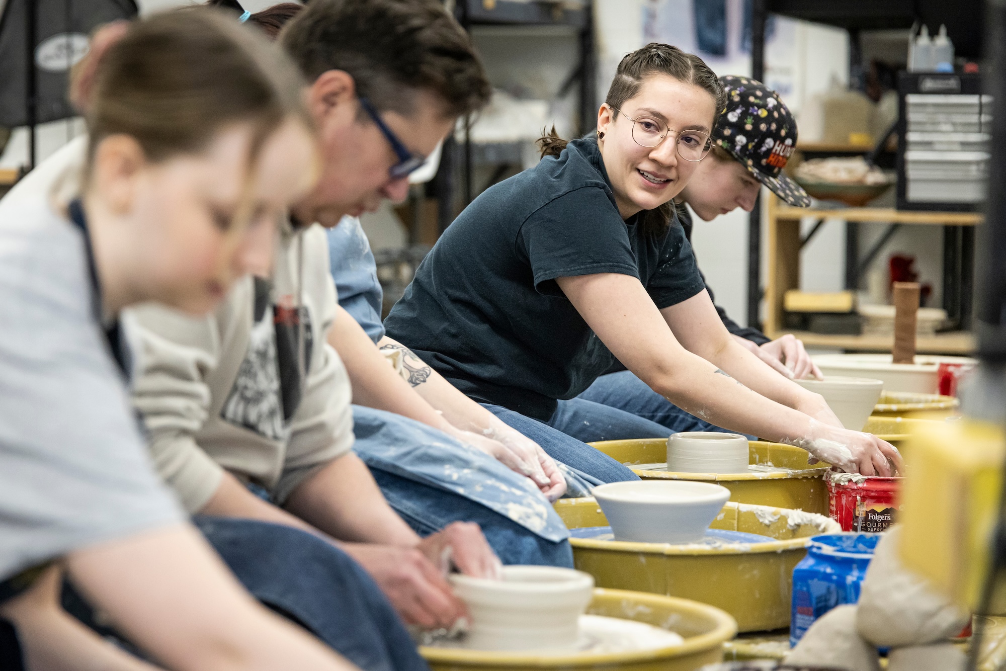 Students creating bowls in ceramics class.