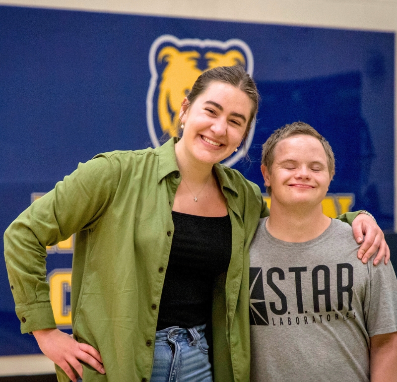 two students are smiling together looking directly at the camera while attending the end of year celebration for the goal program