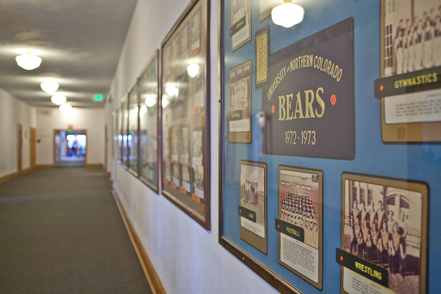 Photo gallery of awards, teams and jerseys displayed inside Gunter Hall.