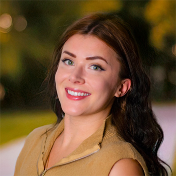 Young women, with long dark hair, wearing a yellow shirt.