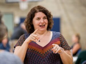 A lady is shown communicating in sign language