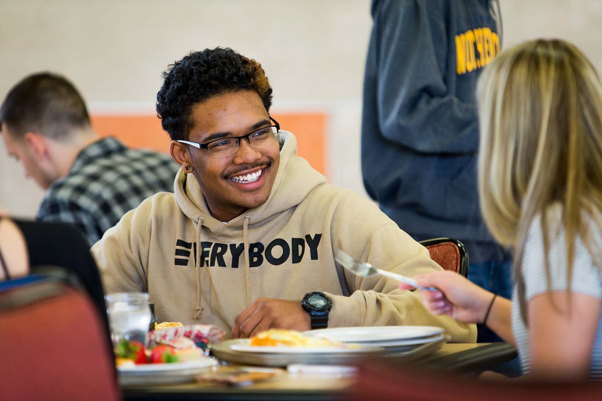 A student wearing a hoodie that says 
