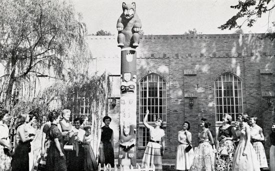 The class of 1930 pose with the Totem Teddy display on campus.