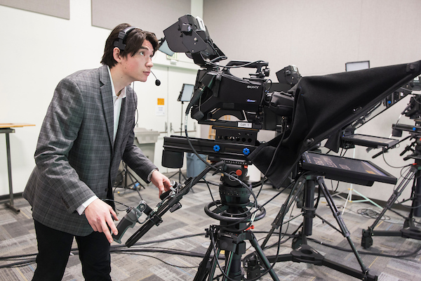 A Journalism student behind a camera