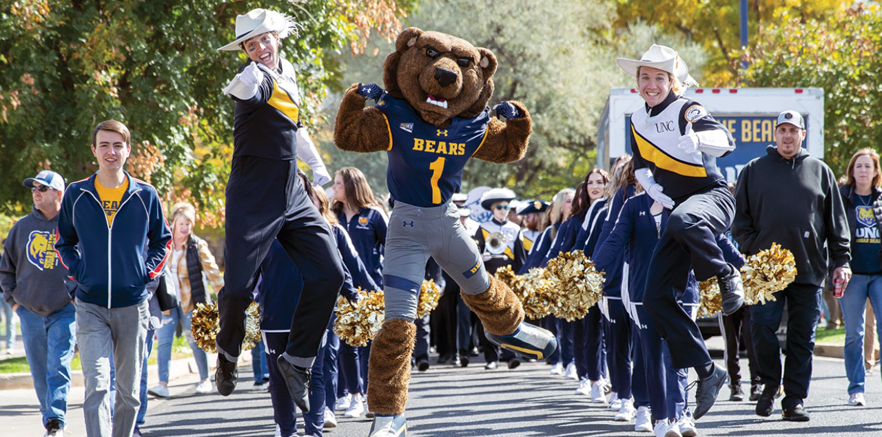 The 100th UNC Homecoming Parade, featuring Klawz the bear and the UNC marching band.