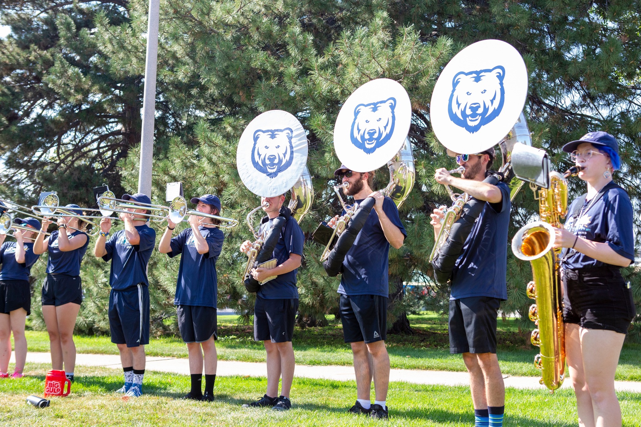 Pride of the Rockies marching band playing outdoors on campus.