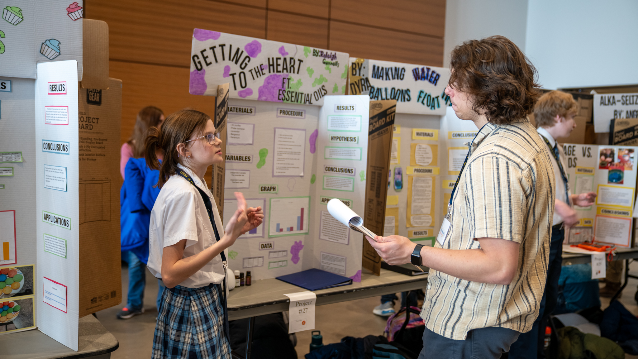 Student explaining their science project on the effects of Essential Oils