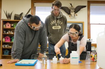 Students in a geography classroom studying the PH of water