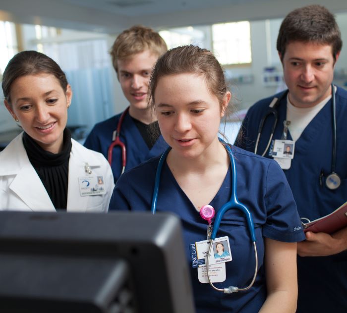 Three Nursing students receiving instruction