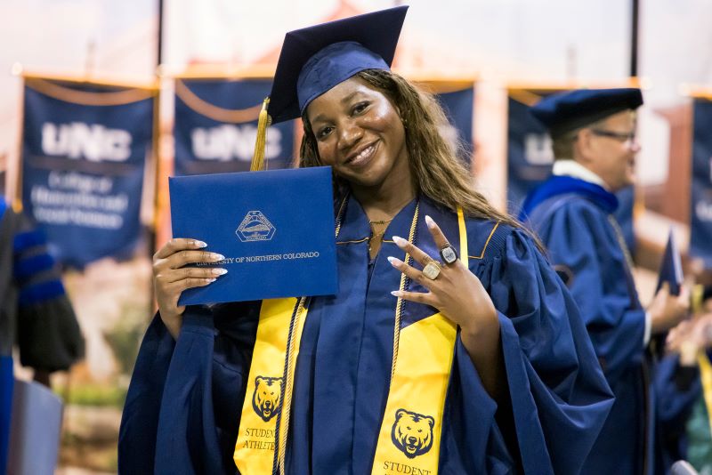 Graduating student holding diploma