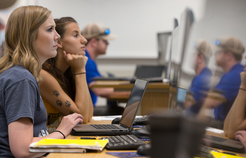 Three students in a criminology classroom