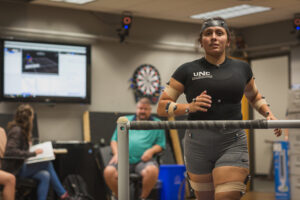 Female athlete running tests on treadmill with sensors attached for measurements