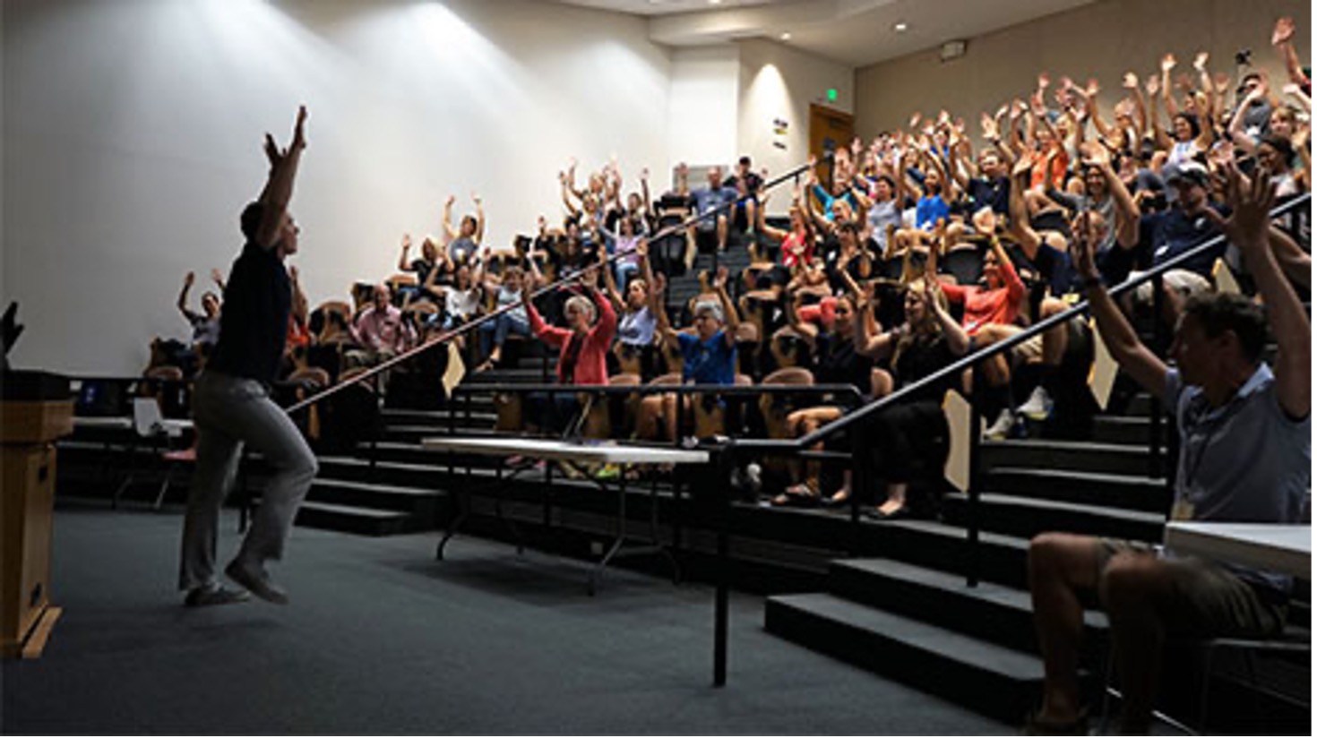 Teacher and class engaging in an active learning exercise to promote movement in classroom settings