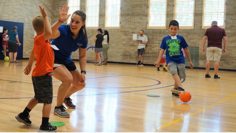 Teacher high fiving student after a game to celebrate an accomplishment