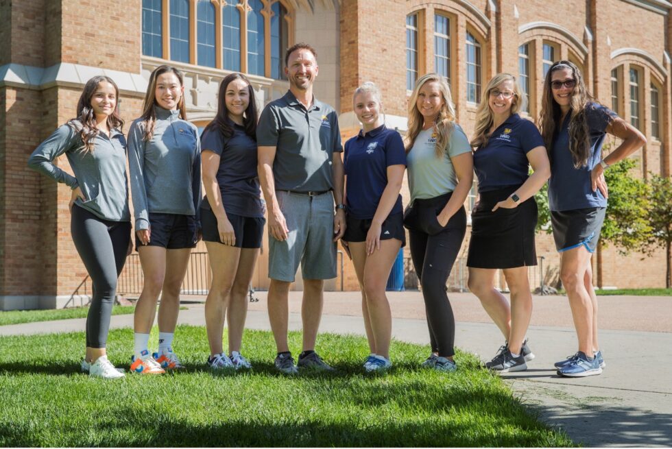 A group photo fo the Active Schools Institute team. There are 8 people standing together in front of Gunter Hall