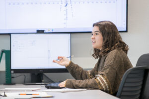Student explaining graphs on computer screen