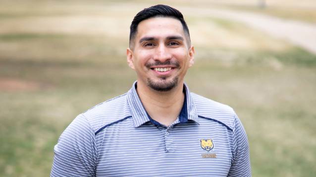 UNC student Brandon Lagunas smiling at the camera while wearing a UNC polo shirt.