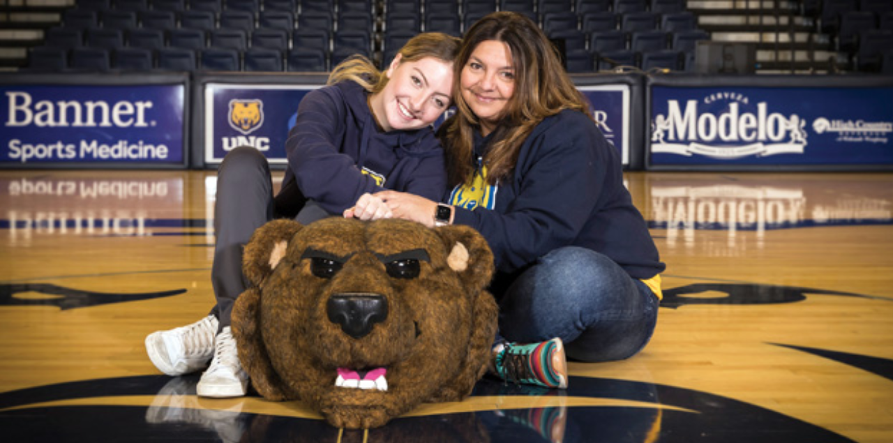 Mother-daughter duo Dana Hoffman and Maddie Cabot posing with the Klawz mascot outfit