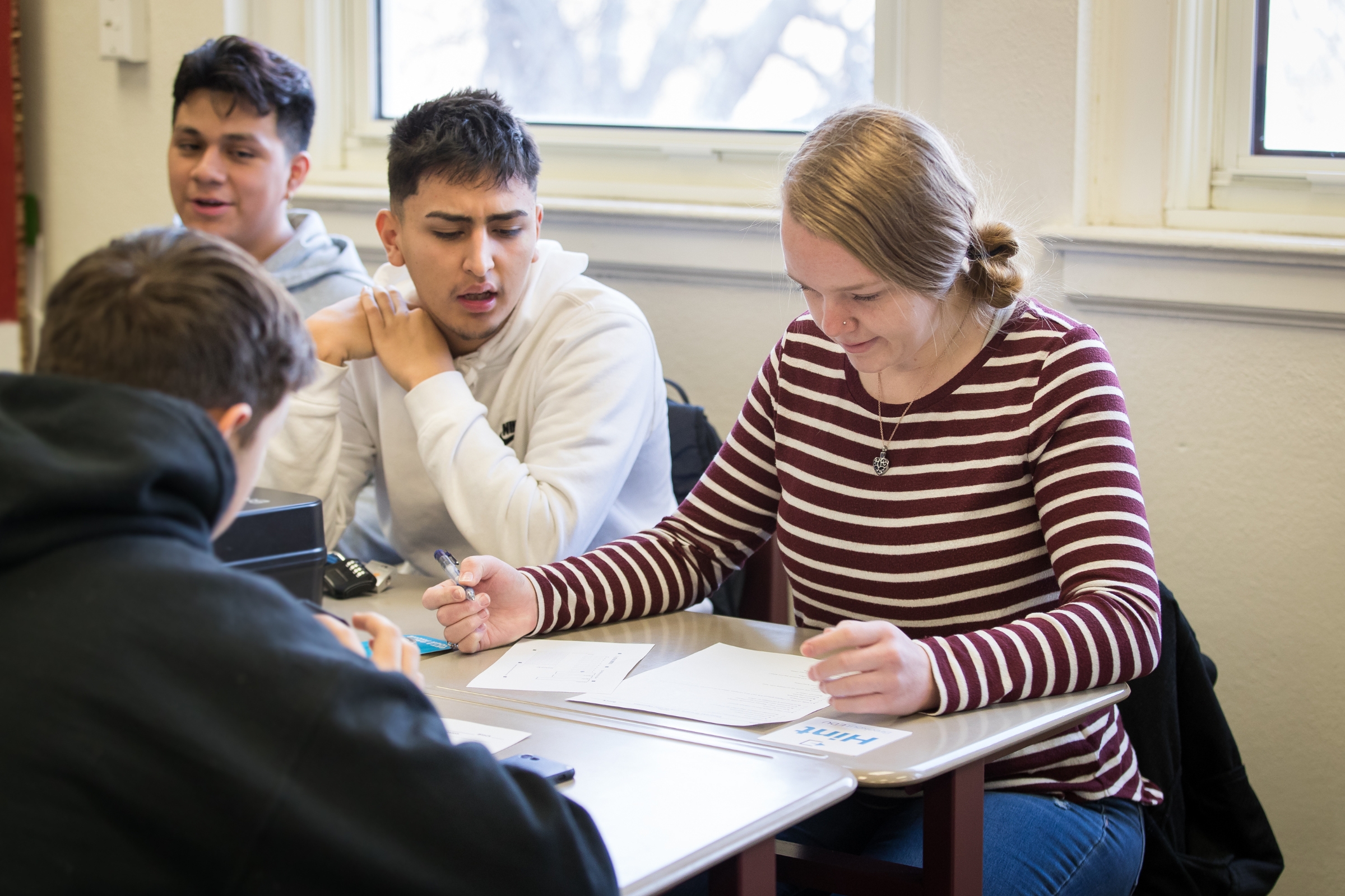 A group of high school students are working on an assignment